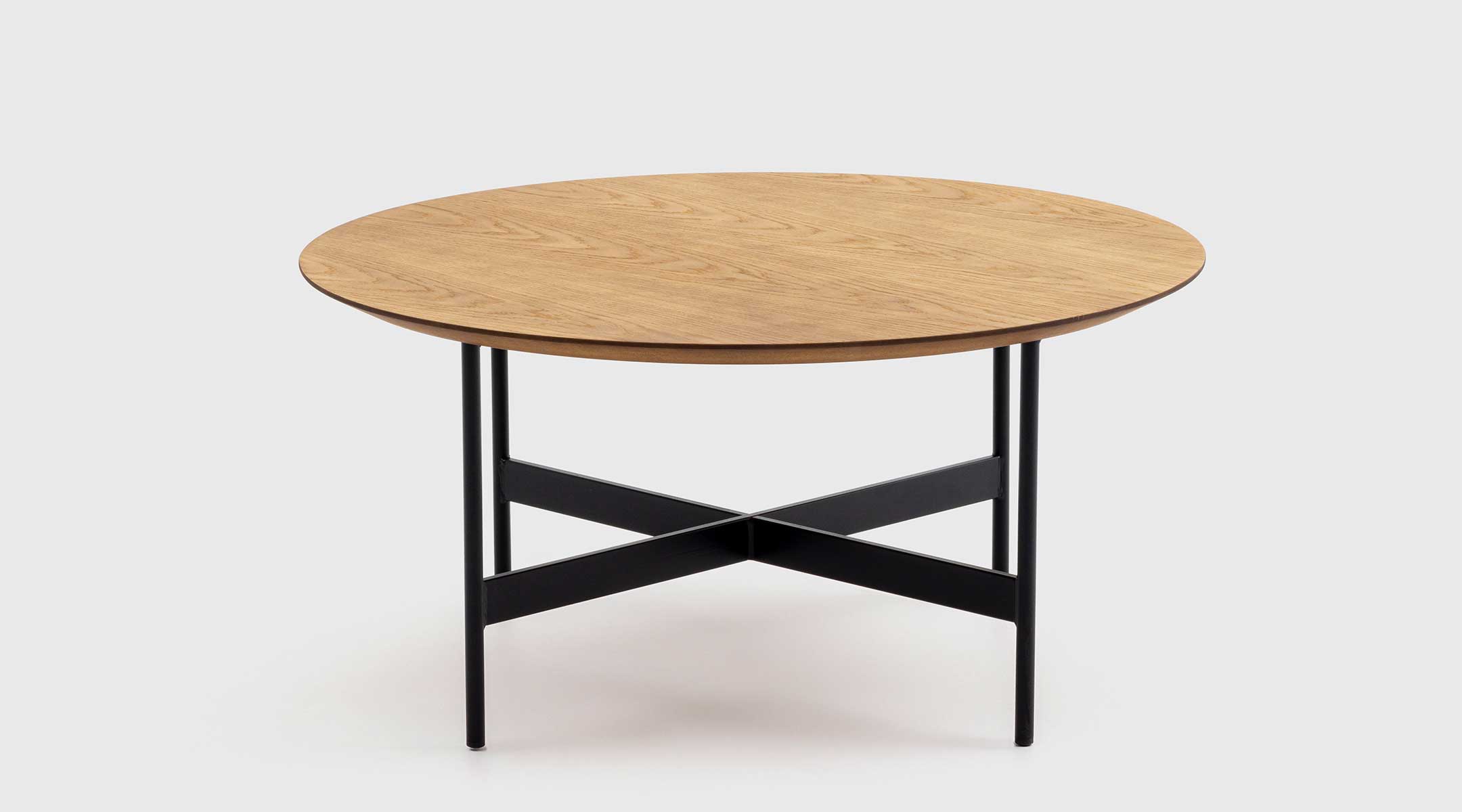 Mesa de centro Odei de Mimma Gallery con tablero redondo de roble y base negra en forma de cruz, diseño moderno y funcional de 80 cm de diámetro.
