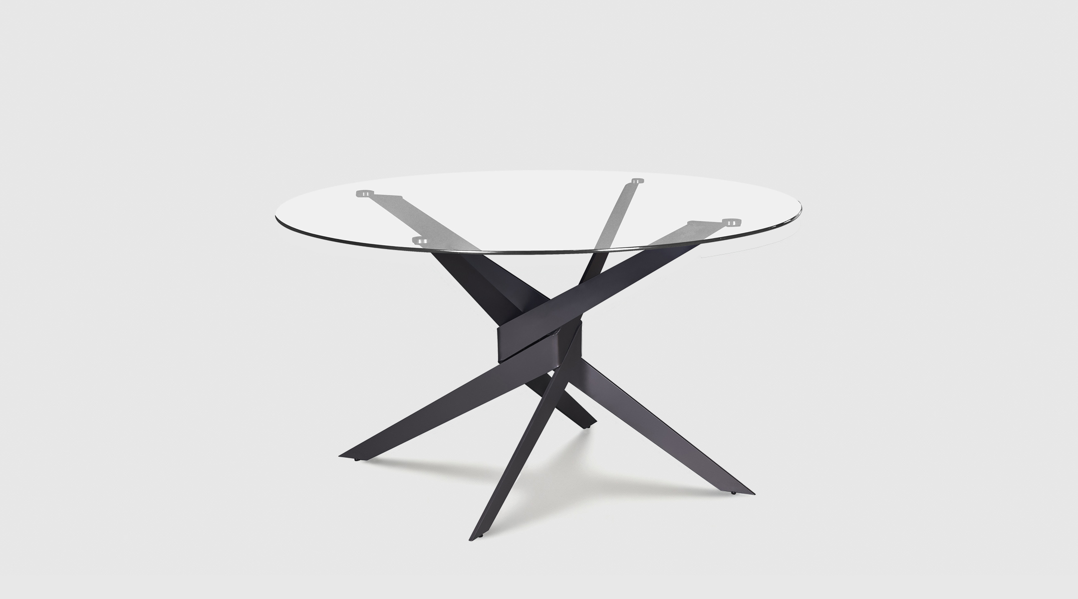 Mesa redonda Moor de Mimma Gallery con sobre de cristal templado y base metálica negra entrelazada, diseño minimalista y elegante de Ø120 cm.